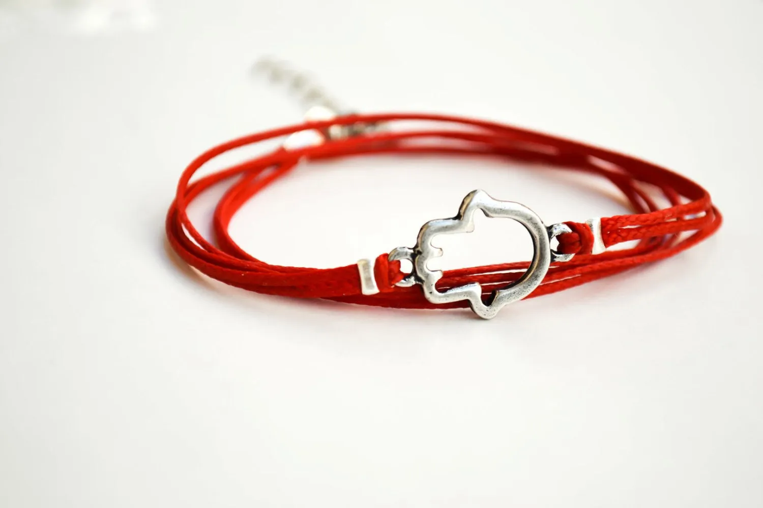 Red wrapped bracelet with a silver Hamsa charm, Kabbalah bracelet