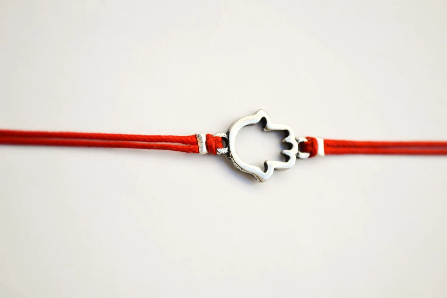 Red wrapped bracelet with a silver Hamsa charm, Kabbalah bracelet
