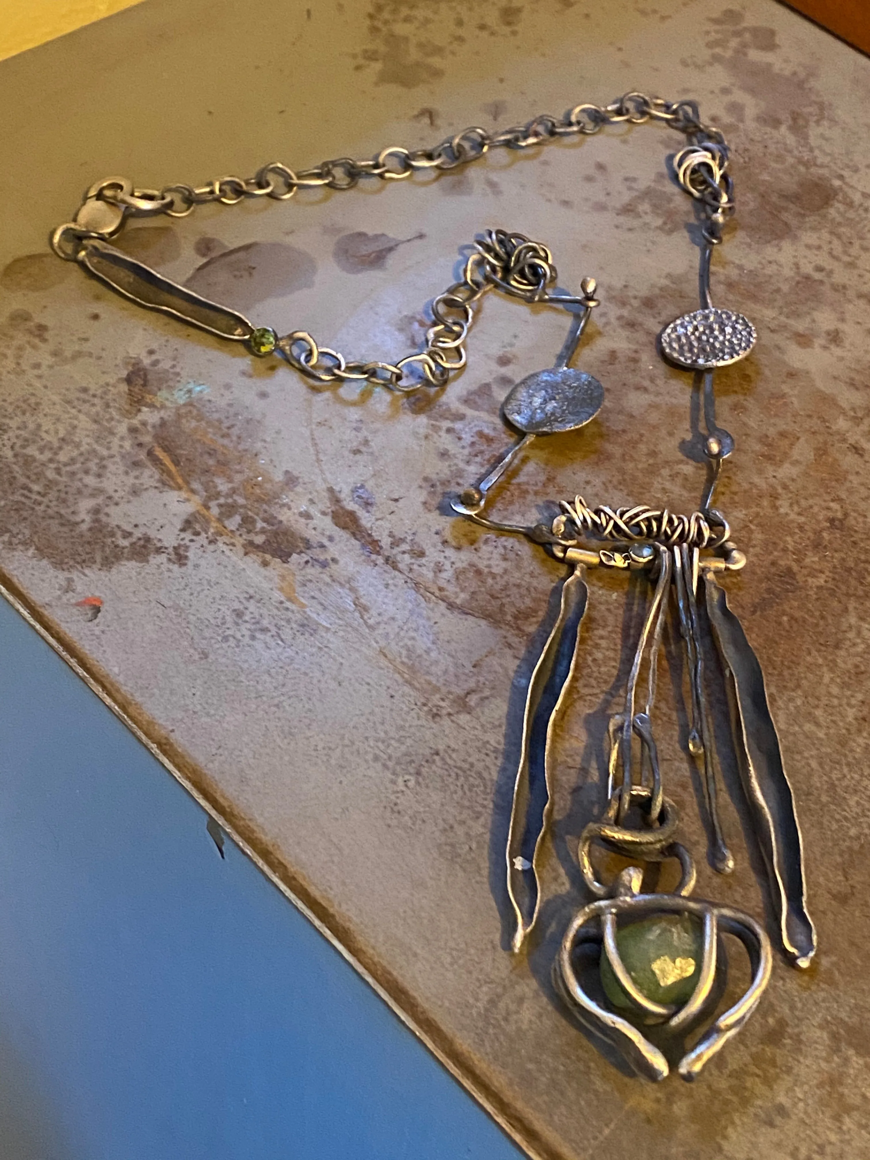 Sculptural Necklace with Blue Topaz and Caged Green Rough Stone